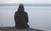 Person sitting by water
